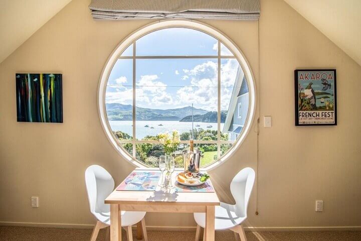 The dining area at the Boathouse features a unique round window with gorgeous harbour views.