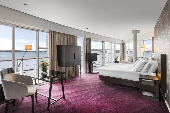 A large room at Hilton Auckland with sweeping waterfront views