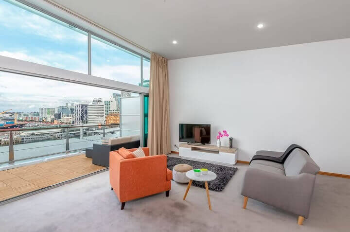 The living area and balcony overlooking the harbour at the penthouse apartment on Princes Wharf