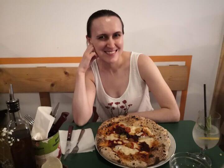 Ksenia enjoying her pizza at Rudy's Ancoats