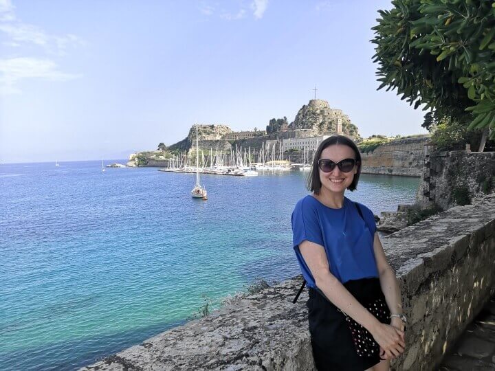 Ksenia is standing in front of the Old Fortress in the Old Town of Corfu