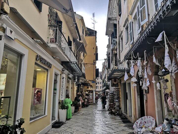 A scenic shopping street line with traditional venetian buildings in Corfu Town